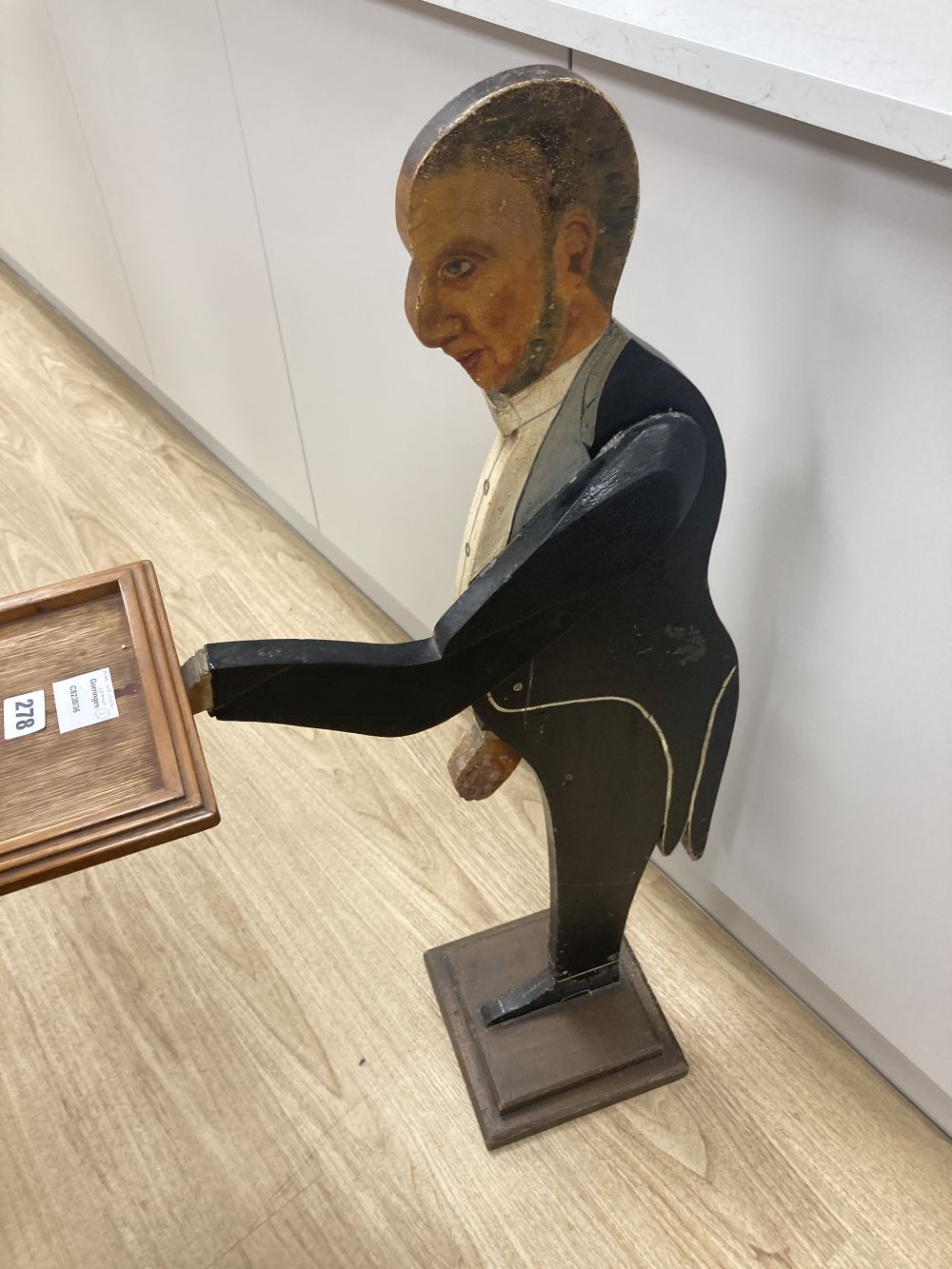 A fret cut painted wood butler stand, height 93cm